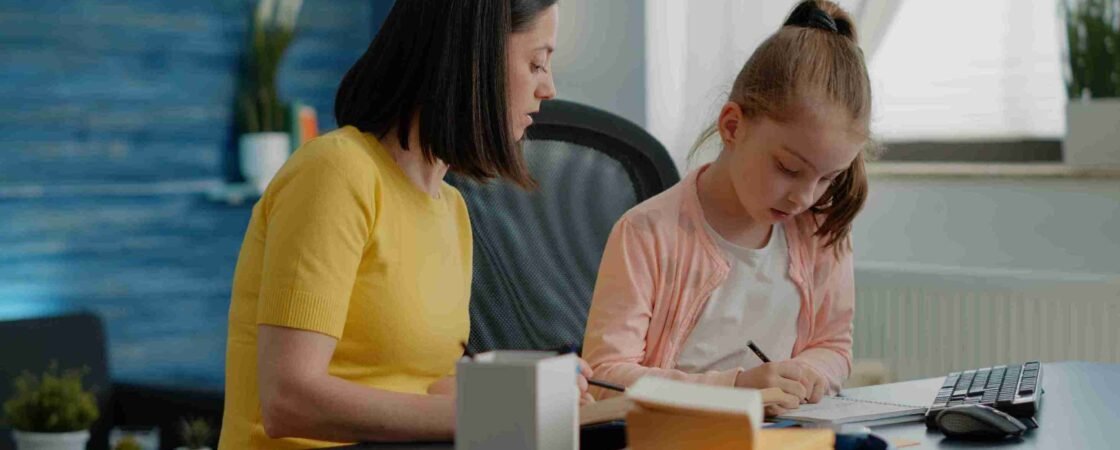 A mother and daughter studying together at a desk, illustrating effective SATs Study Tips for primary school children.