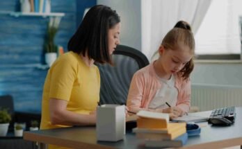 A mother and daughter studying together at a desk, illustrating effective SATs Study Tips for primary school children.